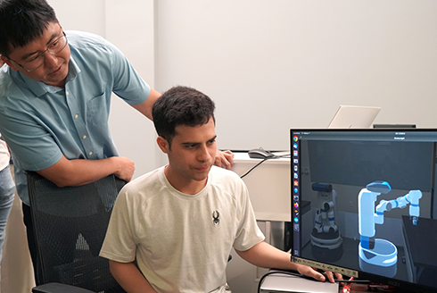 Professor with student at computer