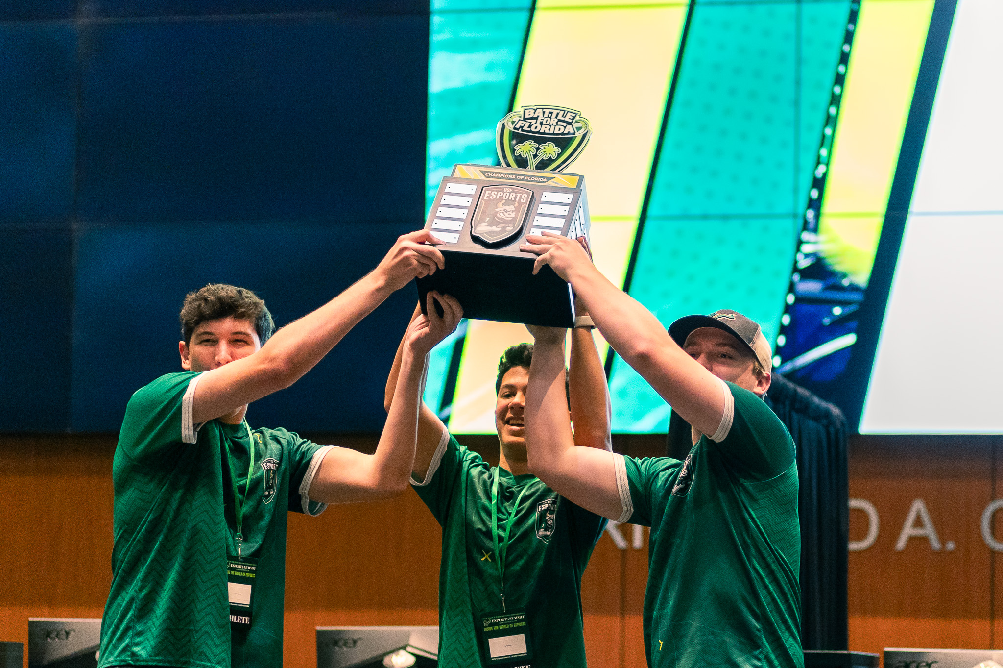 Three USF students attended an esports event and won a trophy.