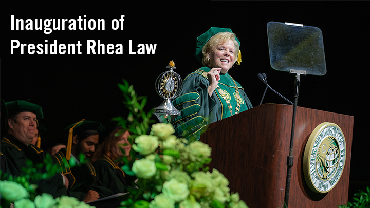 Rhea Law standing behind a podium with the USF seal with text reading "Inaguration of President Rhea Law".