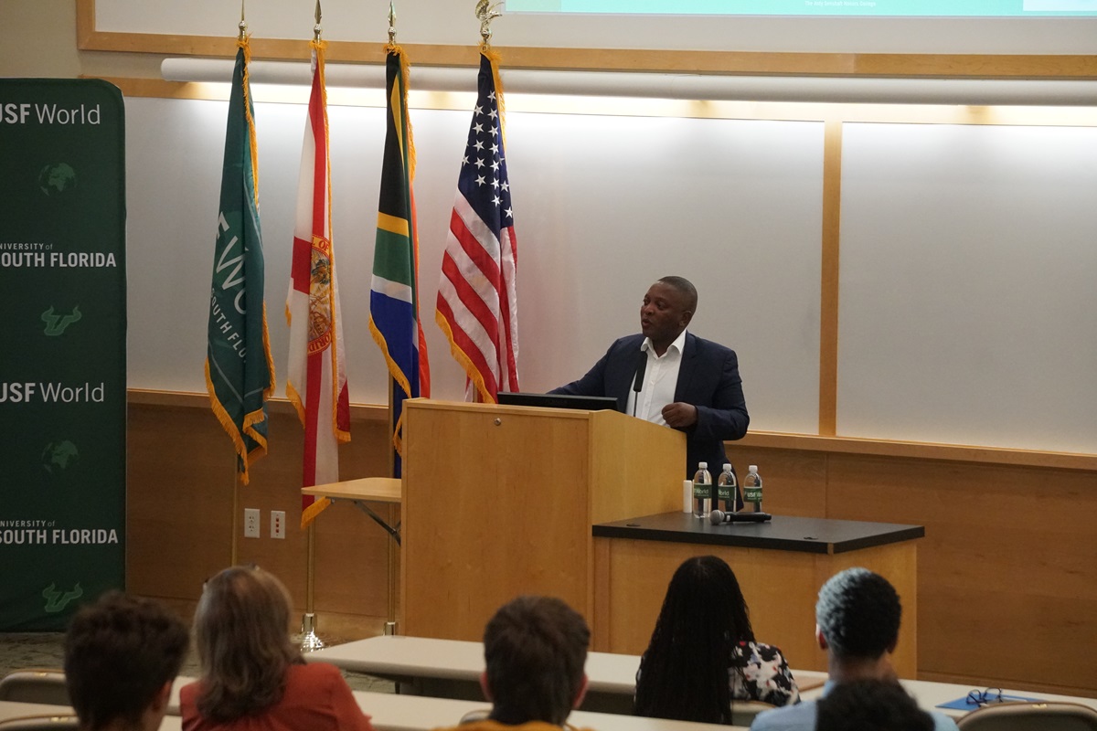 African-American Nkosinathi Biko speaks behind a podium about the rights work of his father, Steve Biko