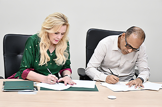 BITS Pilani and USF representatives signing an official document