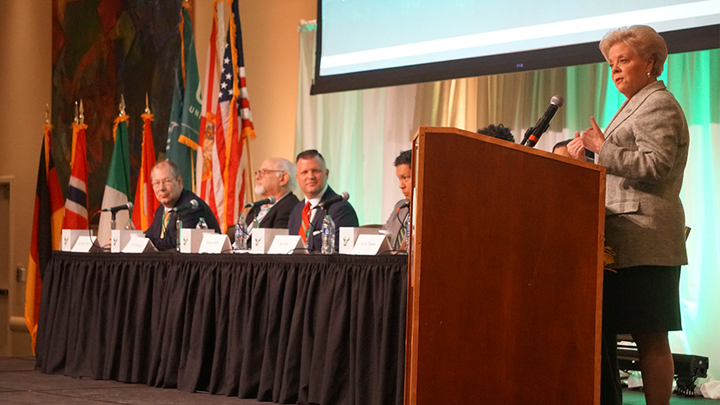 USF President Rhea Law speaks at a podium to business and university leaders