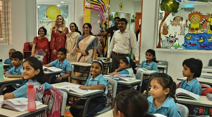 representatives from USF World, NextGen International School, and the Founder of the institution observing a classroom of pupils in India