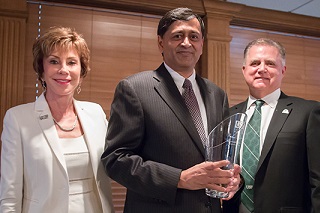 Former USF President, Judy Genshaft (left) and College of Engineering Dean, Bob Bishop (right) standing with distinguished alumnus Kumar Ramachandran (center)