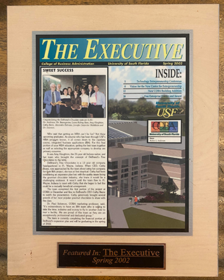 A plaque of a news article that was featured on "The Executive" in Spring 2002