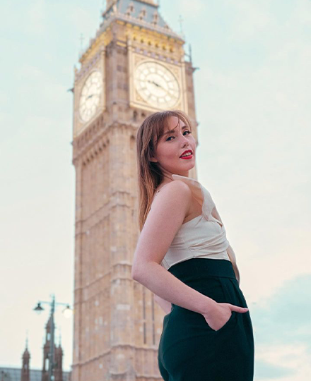 USF student, Gabrielle Sell, standing in profile in front of the Big Ben clock in London, England