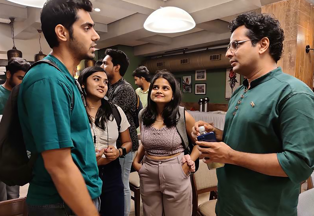 USF alumnus and Indian actor, Ojas Rawal (right), speaks to incoming USF Indian students about what to expect this Fall.