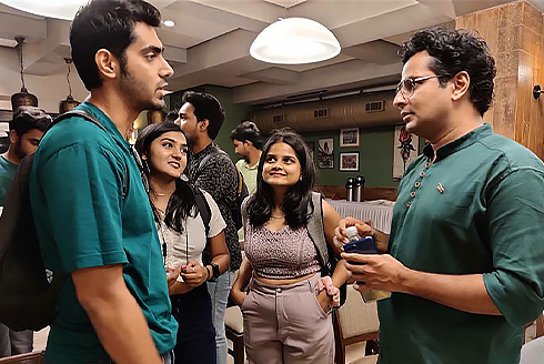 USF alumnus and Indian actor, Ojas Rawal (right), speaks to incoming USF Indian students about what to expect this Fall.