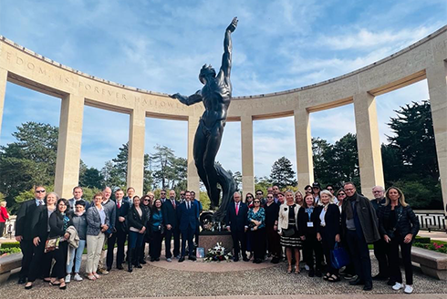 Tampa and Le Havre delgation posing for a photo after participating in a wreath-laying ceremony at the World War II American Cemetery near Omaha Beach in France.