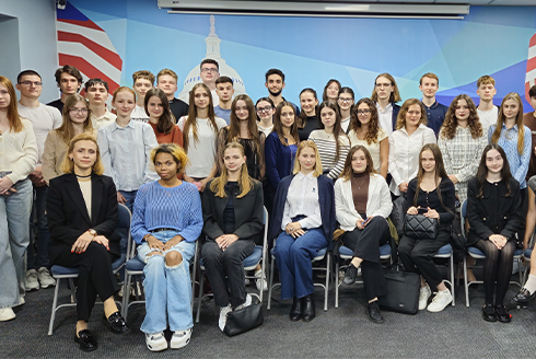 A group of college students standing in a classroom