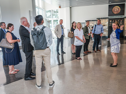 group of people in a bright lobby with tour guide