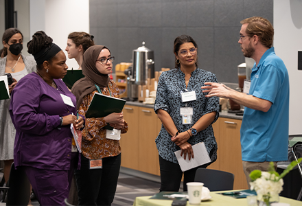 A group of people talking at the event