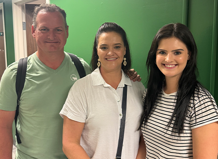 A young girl on the right and her parents on the left