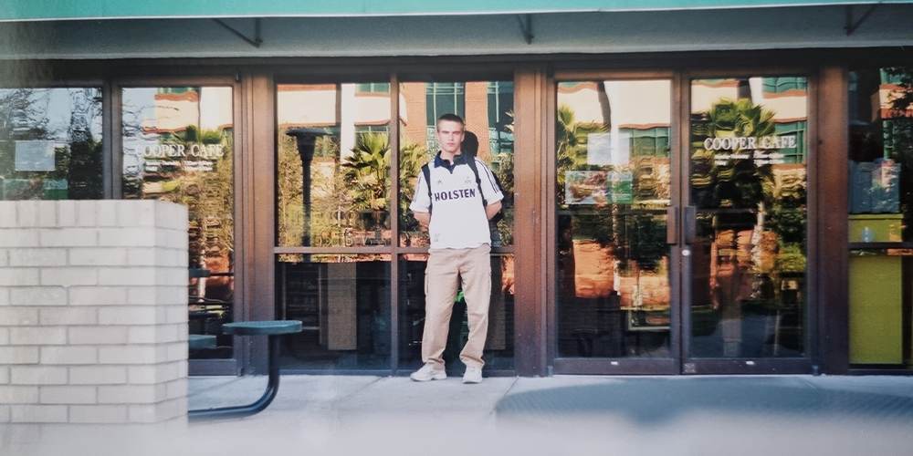 A student standing in front of a USF building