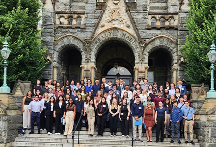 A group of students standing before an old building