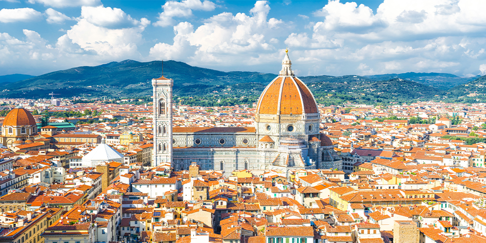 An areal view of florence's distant mountains and close city