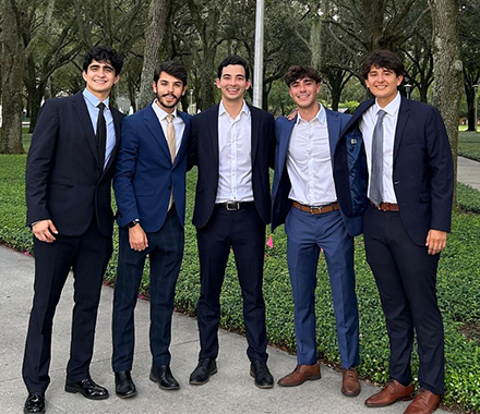 A group of people in suits smiling 