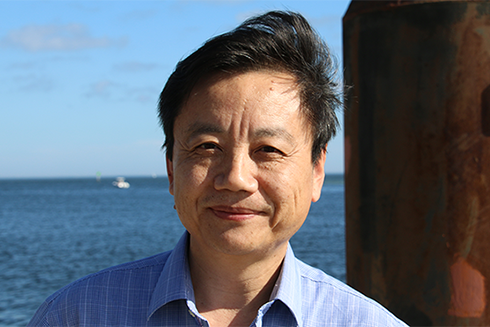 USF Researcher smiling with ocean in background