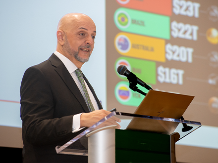 Dr. Pournoor speaks at a podium