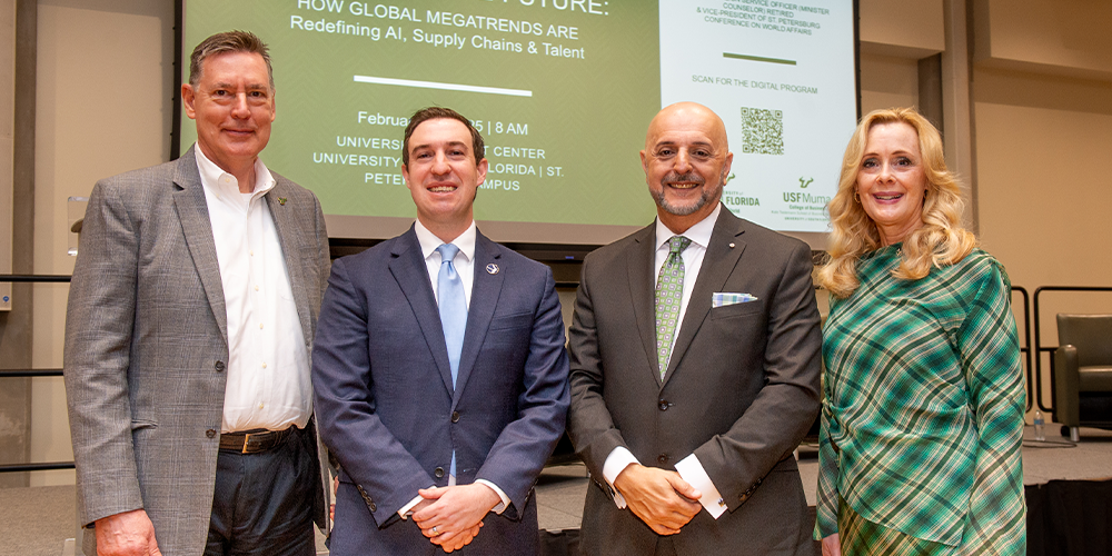 A group of panelists and USF World leadership