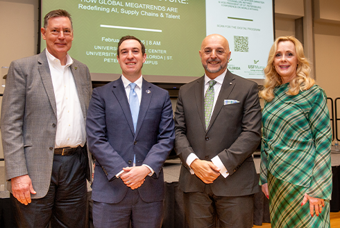 A group of panelists and USF World leadership